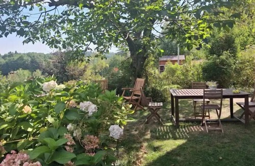 Samone House | A charming stone house set in a hillside garden